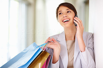 Young woman enjoying a conversation on the phone while shopping