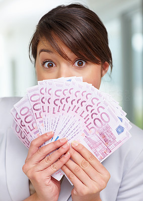 Shocked woman with fan of five hundred Euros