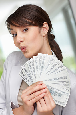 Young woman holding fan of American dollars