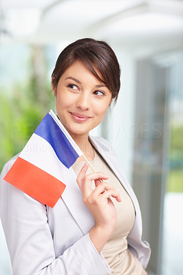 Cute young female with a French flag , looking away