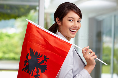 Pretty young woman with an Albanian flag