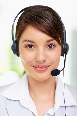 Lovely young woman wearing a headset smiling , call centre