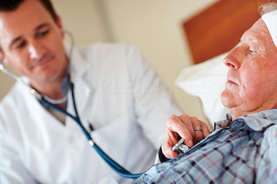 Senior man getting his heart beat checked by a doctor