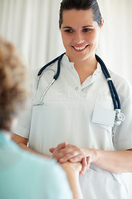 Female nurse speaking to an elderly patient