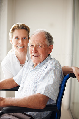 Happy old man on the wheel chair with a nurse