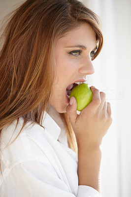 Biting into a juicy green apple