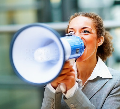 Business woman screaming into a megaphone