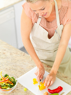 Top view of a housewife preparing salad in the kitchen