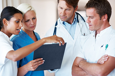 Young doctors discussing on patient\'s medical report
