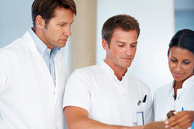 Team of doctors going through medial report