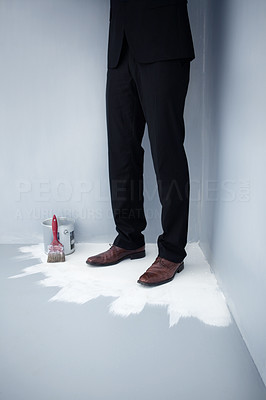 Business man trapped at the corner of a painted floor
