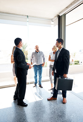 Team of businesspeople standing together in office lobby