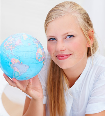 Portrait of a lovely young female holding a globe