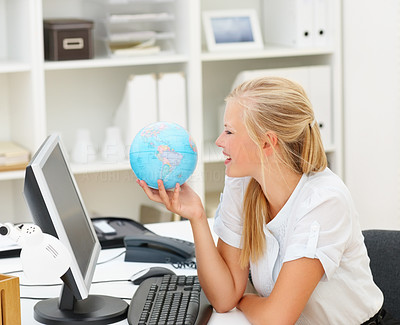 Cute young business woman with a world globe