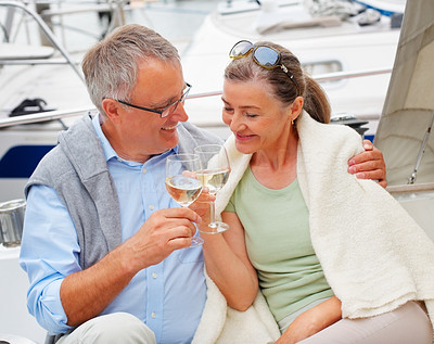 Happy senior couple celebrating with a champagne, sea voyage