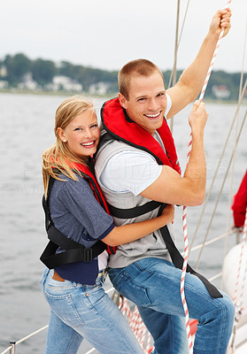 Young couple holding a boat line while on an adventurous sea voyage