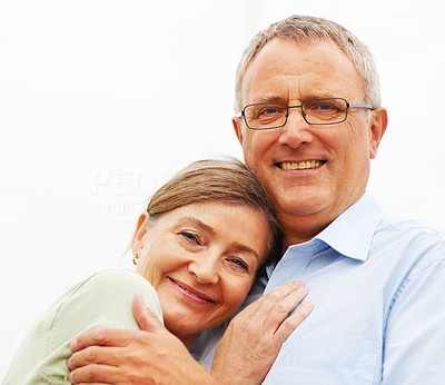Cute mature couple hugging eachother against white background