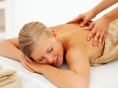 Young woman relaxing while getting a back massage