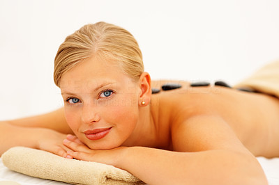 Attractive young female getting a hot stone therapy