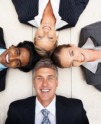 Successful group of business people lying on the floor