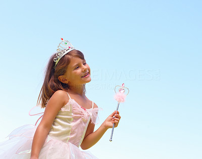 Happy small girl wearing fairy wings against the blue sky