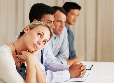 Business woman lost in thought during board meeting
