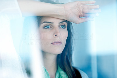Lovely young lady looking through glass window