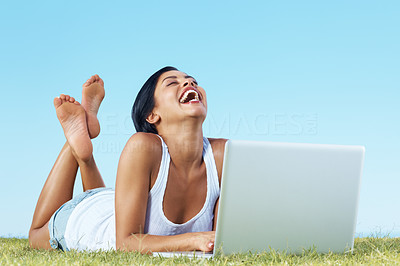 An excited young lady relaxed and using laptop - Copyspace