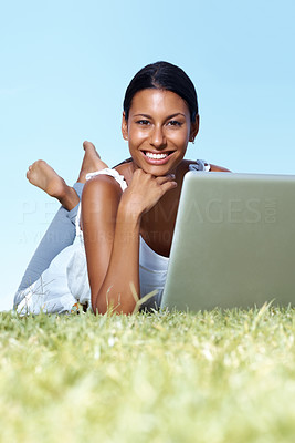 Smiling young lady using laptop and relaxing