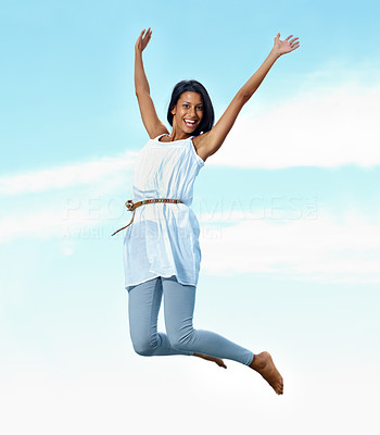 Excited young female jumping in air