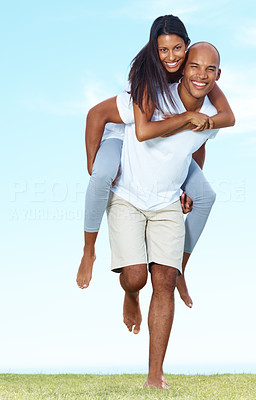 Young female enjoying piggyback ride on her boyfriend