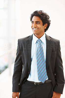 Successful Indian business man looking away, smiling