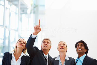 Business man showing something to colleagues, upwards