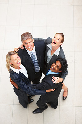 Successful business people forming a huddle