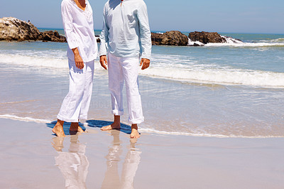 Lower section: Image of a couple standing on the beach