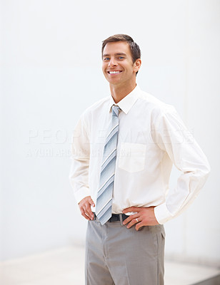 Confident business man smiling with hands hips