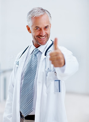 Senior doctor giving a thumbs up sign