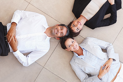Business people lying on the floor and looking upwards