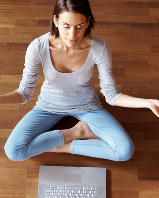 Healthy lifestyle - Young female sitting in lotus position with laptop