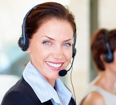 Closeup of a happy young call centre employee at work