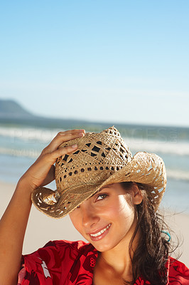 Beautiful woman wearing a cane hat at the beach