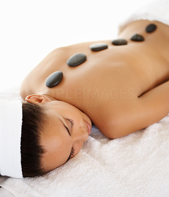 Stone massage therapy: Beautiful woman relaxing at a spa