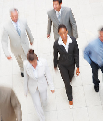 Blurred image of a team of business people, walking