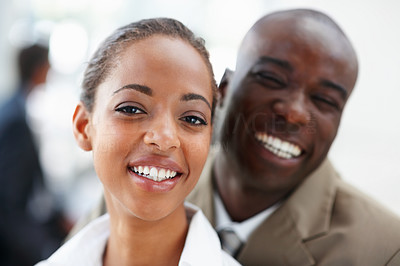Two African American business people smiling together
