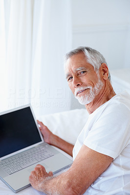A senior retired happy man with a laptop