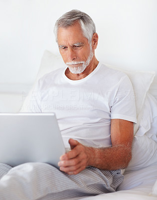 An old man working on a laptop