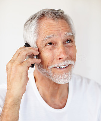 A senior cheerful man speaking on a mobile