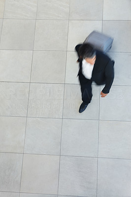 Blurred image of a business man walking with his luggage
