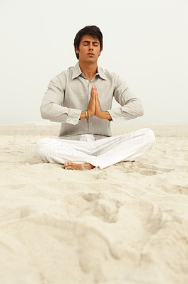 Image of a spiritual man meditating on the beach