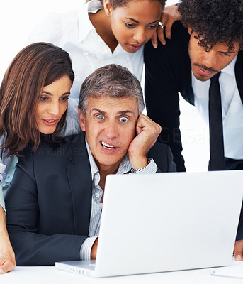 A shocked business team working together on a laptop